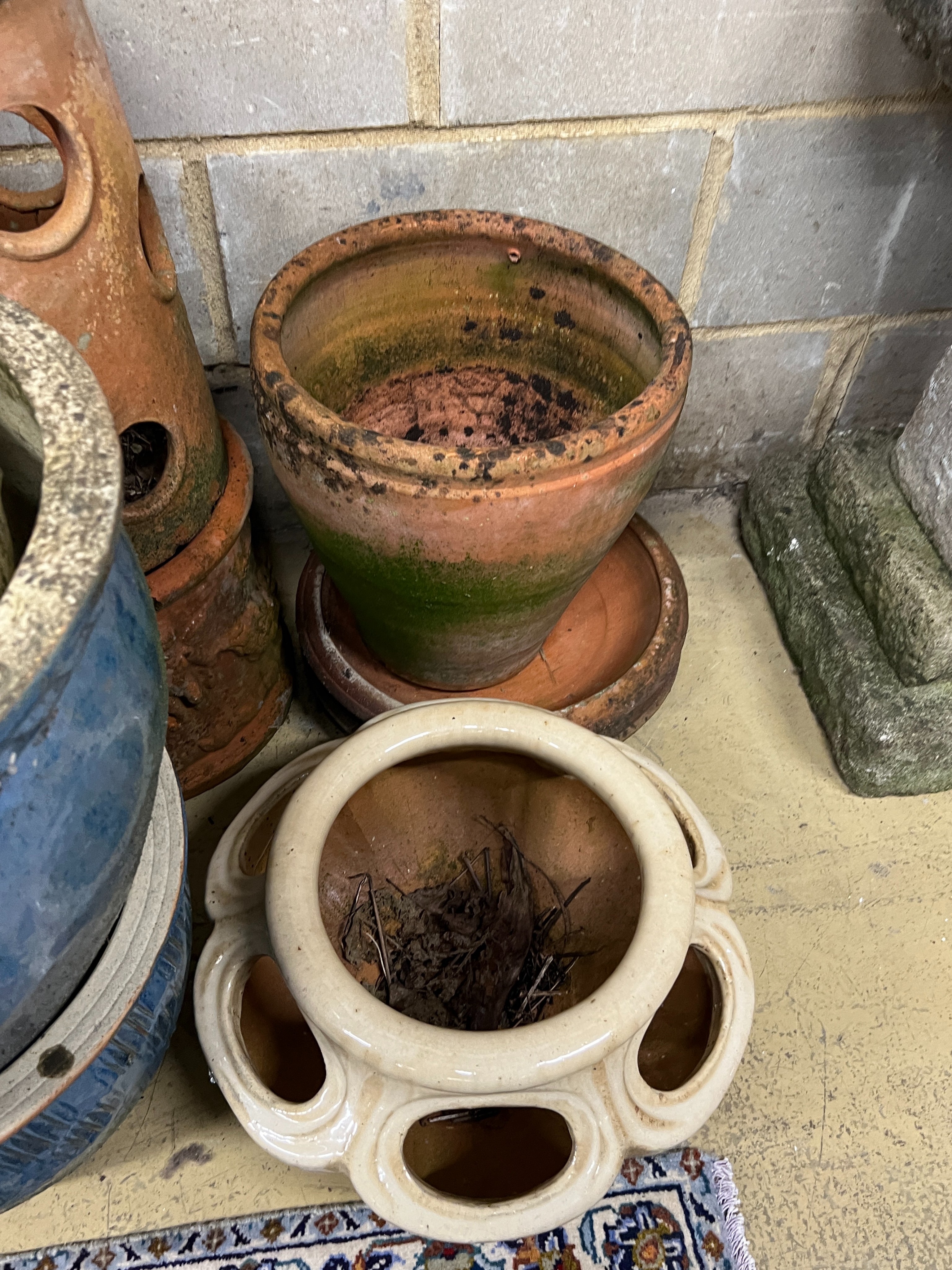 Ten assorted terracotta and glazed earthenware garden planters and three saucer bases, largest diameter 46cm, height 29cm